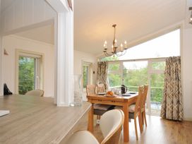 A dining room with a table and chairs at 5 Tree Tops in Dobwalls