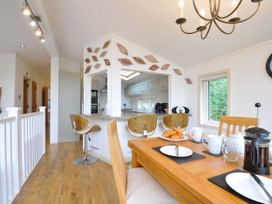 A dining room with a table and coffee maker at 5 Tree Tops in Dobwalls