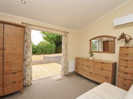 A bedroom with a wardrobe and dresser at 5 Tree Tops in Dobwalls