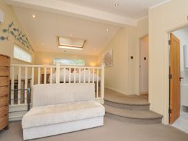 A bedroom with a bed and stairs at 5 Tree Tops in Dobwalls