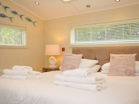 A bedroom with a bed and pillows at 5 Tree Tops in Dobwalls