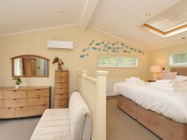 A bedroom with a bed and dressing table at 5 Tree Tops in Dobwalls