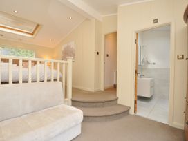 A bedroom with a bed and a bathroom entrance at 5 Tree Tops in Dobwalls