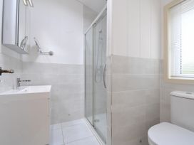 A bathroom with a shower, sink, and toilet at 5 Tree Tops in Dobwalls