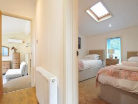 A bedroom with two beds and a chest of drawers at 5 Tree Tops in Dobwalls