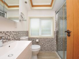 A bathroom with a sink, toilet, and shower at 5 Tree Tops in Dobwalls