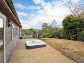 An outdoor area with a hot tub and decking at 5 Tree Tops, Dobwalls