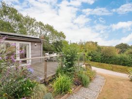 An outdoor area with decking and plants at 5 Tree Tops in Dobwalls