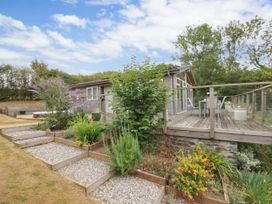 An outdoor view of a house with deck and garden at 5 Tree Tops in Dobwalls