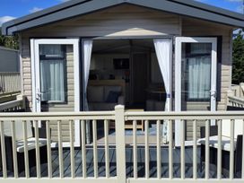 An outdoor area with doors and furniture at Beverley Bay in Paignton