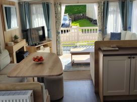 A living room with a sofa and television at Beverley Bay in Paignton