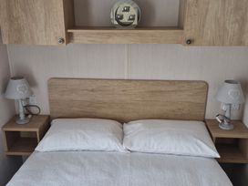 A bedroom with a bed and bedside tables at Beverley Bay in Paignton