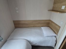 A single bed with a headboard in a bedroom at Beverley Bay in Paignton