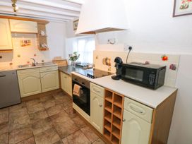 A kitchen with sink, oven, and microwave at The Stable in Haverfordwest