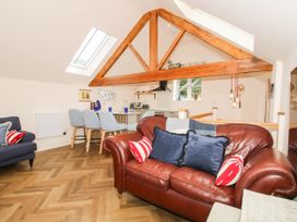 A living room with a sofa and dining area at Little Red Barn Wallop near Westbury