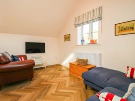A living room with a television and seating at Little Red Barn in Wallop near Westbury