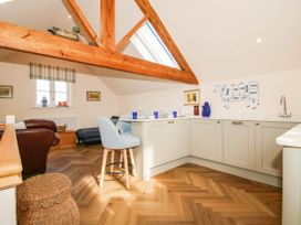 A kitchen area with a table and chairs at Little Red Barn in Wallop near Westbury