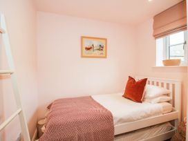 A bedroom with a bed and window at Little Red Barn in Wallop near Westbury