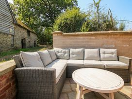 An outdoor seating area with a sofa and coffee table at Little Red Barn in Wallop near Westbury