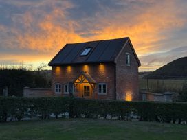A house with solar panels and windows at Little Red Barn in Wallop near Westbury