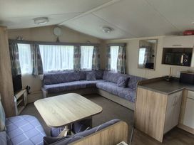 A living room with couch and table at Heatherview Willerby in Bishop Auckland