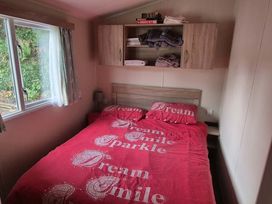 A bedroom with a bed and shelves at Heatherview Willerby in Bishop Auckland