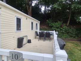 An outdoor area with a dining table and chairs at Heatherview Willerby in Bishop Auckland