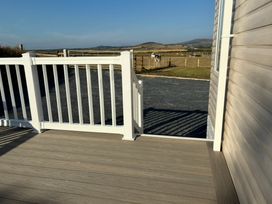 An outdoor deck with railing and a view of the landscape at Bwlchgwyn - Bwlchgwyn Caravan, Aberdaron Pwllheli