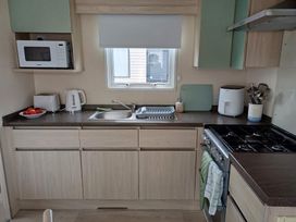 A kitchen with appliances and utensils at Glendale holiday park in Wigton