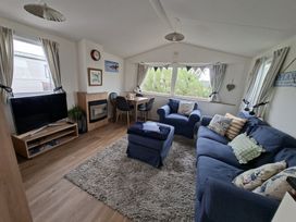 A living room with a sofa and television at Demelza (B34) Seven Bays Holiday Park, Padstow