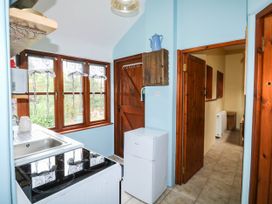A kitchen with a sink, stove, and refrigerator at The Old Forge in Kingsbridge