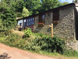 A building with stone wall and flower boxes at The Old Forge Hallsands