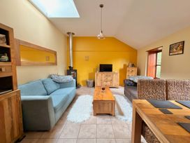 A living room with a sofa and coffee table at The Old Forge in Hallsands