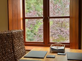A dining room with a table and a window at The Old Forge in Hallsands