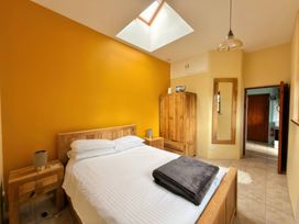 A bedroom with a bed and a wardrobe at The Old Forge in Hallsands