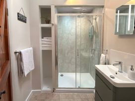 A bathroom with a shower and sink at The Old Forge in Hallsands