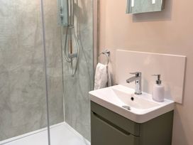 A bathroom with a shower and sink at The Old Forge Hallsands