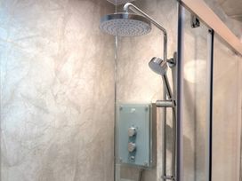 A shower with a showerhead and handheld shower at The Old Forge Hallsands