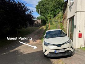 A car parked in a designated guest parking area at The Old Forge in Hallsands