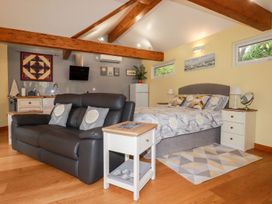 A living room with a sofa and bed at Brambleside Lodge in Truro