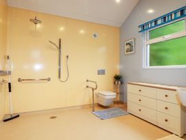 A bathroom with a shower, toilet, and sink at Brambleside Lodge, Truro