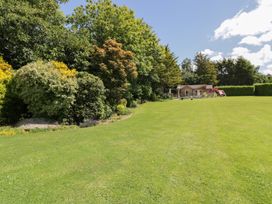 A garden with a house and lawn at Brambleside Lodge in Truro