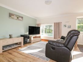 A living room with a television and a sofa at Lower Brambleside in Truro