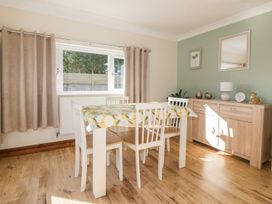 A dining room with a table and chairs at Lower Brambleside in Truro
