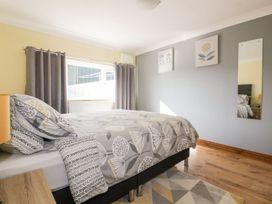 A bedroom with a bed and window at Lower Brambleside in Truro
