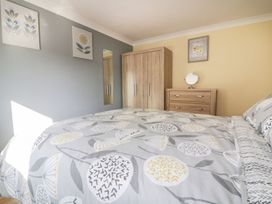 A bedroom with a bed and furniture at Lower Brambleside in Truro