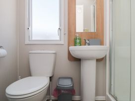 A bathroom with a toilet and sink at 14 Pines Cayton Bay
