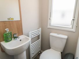 A bathroom with a sink and toilet at 14 Pines in Cayton Bay