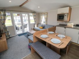 A living room with a dining table and sofa at 14 Pines Cayton Bay