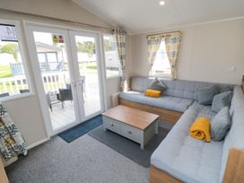 A living room with a sofa and coffee table at 14 Pines Cayton Bay